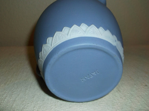 Blue and white pitcher with greek figures