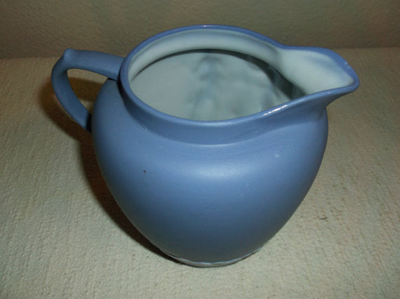 Blue and white pitcher with greek figures